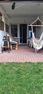 a porch with a hammock on a house at U Julii 2 in Okuninka