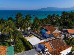 an aerial view of a beach with palm trees and the ocean at 4be Cá Heo in Cầu Sông Kinh