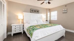 a bedroom with a white bed and a white dresser at Luxurious 2BR 2BA Ocean Pointe Condo Tavernier Fl in Tavernier