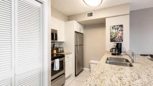 a kitchen with a sink and a counter top at Luxurious 2BR 2BA Ocean Pointe Condo Tavernier Fl in Tavernier +29 photos