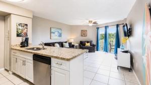 a kitchen with a sink and a living room at Luxurious 2BR 2BA Ocean Pointe Condo Tavernier Fl in Tavernier