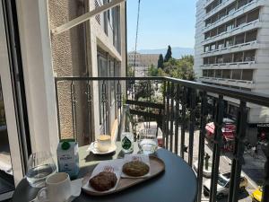 a table with two plates of food on a balcony at White Rose Athens Residence in Athens