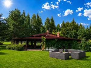 a pavilion with couches in the grass in front at Resort Klewinowo in Klewinowo