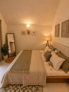a bedroom with a large bed with a lamp on it at Luxurious boho pool villa nandi hills in Bangalore