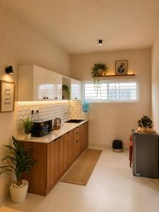 a kitchen with a sink and a counter top at Luxurious boho pool villa nandi hills in Bangalore