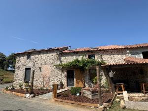 a stone house with a porch at Chambre K-arole in Pouzauges