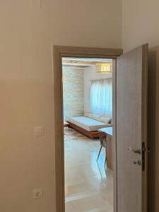 a room with a door leading to a bedroom at Aigialos Villas with Private Beach by Hospi Living in Ferma