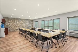 a large conference room with a long table and chairs at Home Inn & Suites Regina Airport in Regina