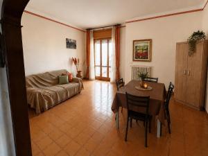a living room with a table and a couch at Dimora Giovanna in Poggiardo