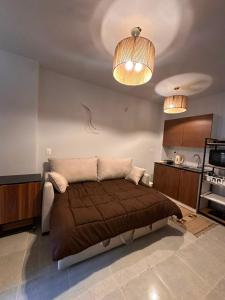 a bedroom with a bed and two lights on the ceiling at Agora resort north coast in Dawwār Abū Maḩrūs