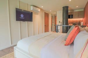 a bedroom with a bed with a television on the wall at Casa México in Mexico City