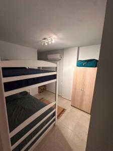 a small room with a bunk bed and a cabinet at Agora resort north coast in Dawwār Abū Maḩrūs