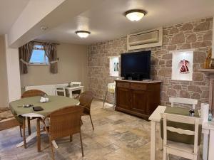 a living room with a table and a television at Gule Cunda in Ayvalık