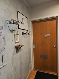 a hallway with a wooden door and a wall at Quiet room near everything in a shared apartment in Helsinki