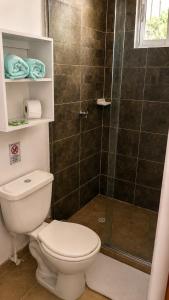 a bathroom with a toilet and a shower at HOTEL NATIVOS in La Vega +48 photos