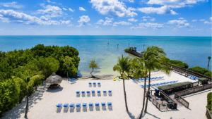 an aerial view of a beach with chairs and the ocean at Luxurious 2BR 2BA Ocean Pointe Condo Tavernier Fl in Tavernier