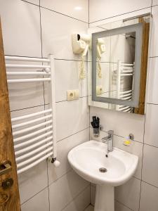 a white bathroom with a sink and a mirror at Hotel Gold Kazbegi in Kazbegi +54 photos