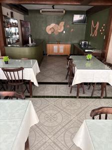 a dining room with tables and chairs in a restaurant at Hotel Coqueiral in Recife +23 photos
