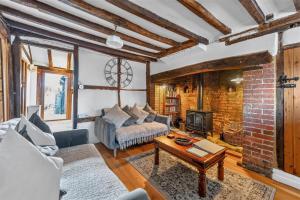 a living room with a couch and a table at Ye Olde Cottage in Crawley