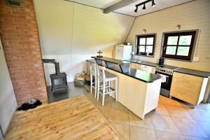 a kitchen with a counter and a stove top oven at PrzyTuLasek - domek pod lasem w sercu natury, blisko Energylandii in Zator