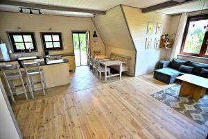 a living room with a couch and a table at PrzyTuLasek - domek pod lasem w sercu natury, blisko Energylandii in Zator