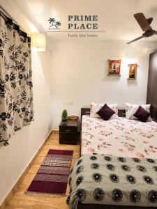 a bedroom with a bed and a sign that reads prime placefacts like home at spectrum hub beach side apartment in Candolim +2 photos