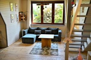 a living room with a couch and a table at PrzyTuLasek - domek pod lasem w sercu natury, blisko Energylandii in Zator