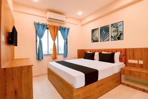 a bedroom with a bed and a tv and a window at Hotel O NamaStay in kolkata