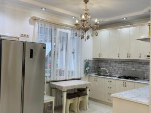 a kitchen with a refrigerator and a table in it at Green House in Dilijan