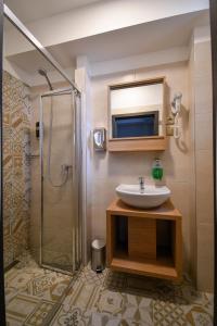a bathroom with a sink and a shower at Hotel Slezská in Muglinov +32 photos