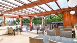 an outdoor dining area with tables and chairs at Hotel Slezská in Muglinov