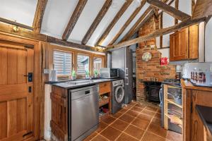 a kitchen with a sink and a dishwasher at Ye Olde Cottage in Crawley +36 photos