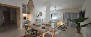 a dining room and living room with a table and chairs at Villa Nour Kélibia in Kelibia