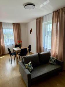 a living room with a couch and a table at Nad Wadągiem in Kieźliny