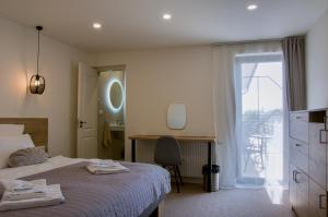 a bedroom with a bed and a desk and a window at Manor 2 in Stará Lesná