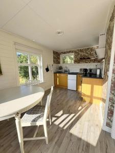 a kitchen with a table and chairs in a room at Tiny House with ocean view in Näs