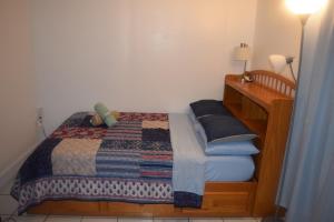 a bedroom with a bed with a quilt on it at Miami Drip Star Life Hostel in Parkway Regional Medical Center Heliport +45 photos