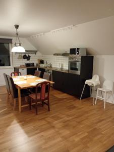 a kitchen and dining room with a table and chairs at Seeblickwohnung Aäng 6 Pool, Billard in Mjöhult