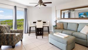 a living room with a couch and a chair and a table at Key Largo 2BR 2BA Oceanfront with Pool in Tavernier