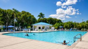 a pool at a resort with people in the water at Key Largo 2BR 2BA Oceanfront with Pool in Tavernier