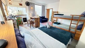 a room with two bunk beds and a desk at Makai Suites in Ubatuba +76 photos
