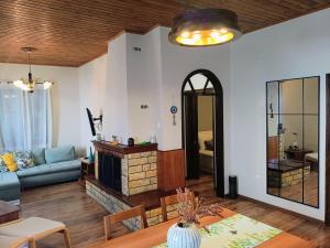 a living room with a couch and a fireplace at Betty's Garden House in Nea Anchialos