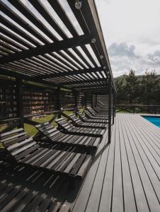 a wooden deck with benches on the side of a pool at Apart-hotel Vershina in Yaremche +93 photos