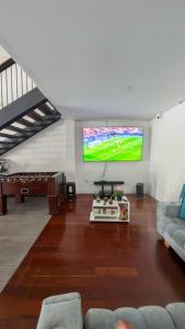a living room with a flat screen tv on the wall at Travesía Quindiana in Filandia