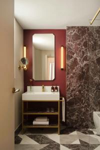 a bathroom with a sink and a mirror at Hotel Urbana, a Tribute Portfolio Hotel in Rome +42 photos