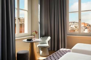 a hotel room with a table and a window at Hotel Urbana, a Tribute Portfolio Hotel in Rome