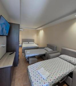 a room with three beds in a room at Vila CANO Boutique in Durrës