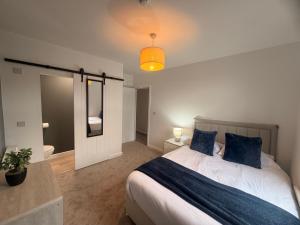 a bedroom with a large bed and a mirror at Brook Terrace in Darlington