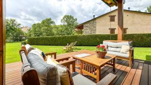 a patio with a table and chairs on a deck at La Maison du Fleuve in Ur