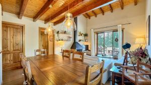 a kitchen and dining room with a wooden table and chairs at La Maison du Fleuve in Ur +19 photos
